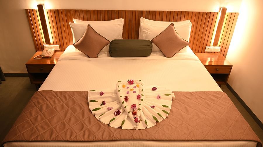 Two swans made of towels and decorated with flowers in the Kutumbh Suite at Mango Leaf Lake Resort, Pune