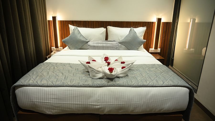 Front view of a A towel shaped in the form of a bouquet kept on the bed at Deluxe room at  Mango Leaf Lake Resort, Pune