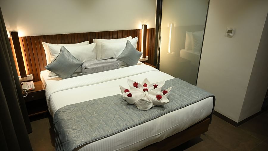 Wide view of the double bed at at Deluxe room at  Mango Leaf Lake Resort, Pune