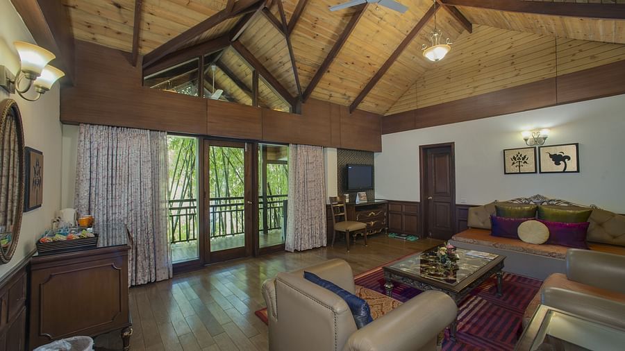 the living room decked with a sofa set and a TV kept above a cabinet - Mayfair Spa Resort & Casino Gangtok