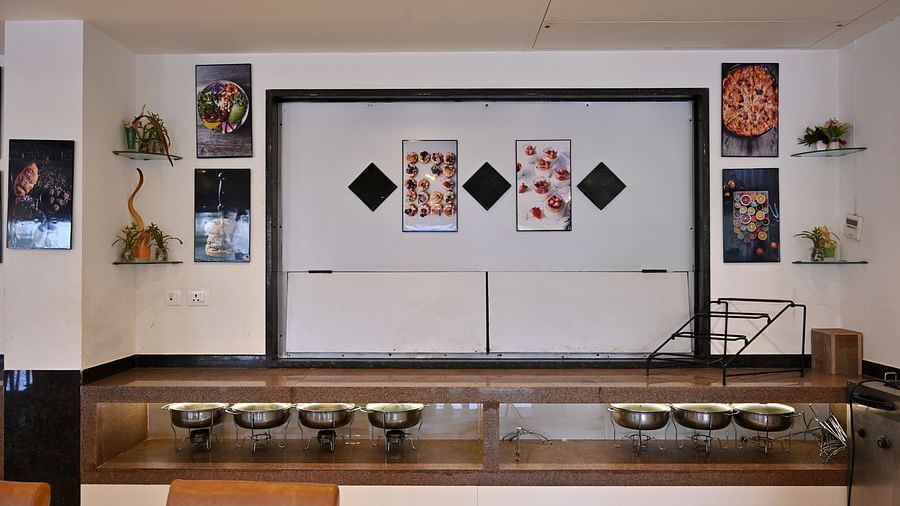 Buffet serving area with warming trays in a hotel restaurant - TGI Insignia, Bhopal