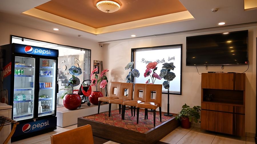Cosy dining corner with a brown leather booth and wooden tables in a restaurant - TGI Insignia, Bhopal