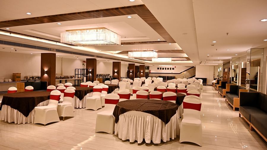 Banquet hall viewed from the end, showcasing the regal chandeliers and polished floors - TGI Insignia, Bhopal