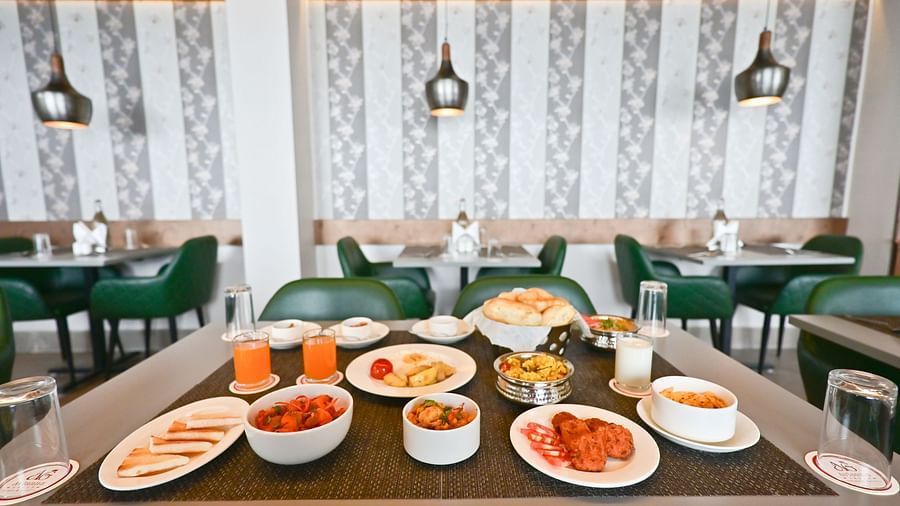 Image of a restuarant and a table filled with food  at The Soma Hotel by Avianna Group, Darjeeling