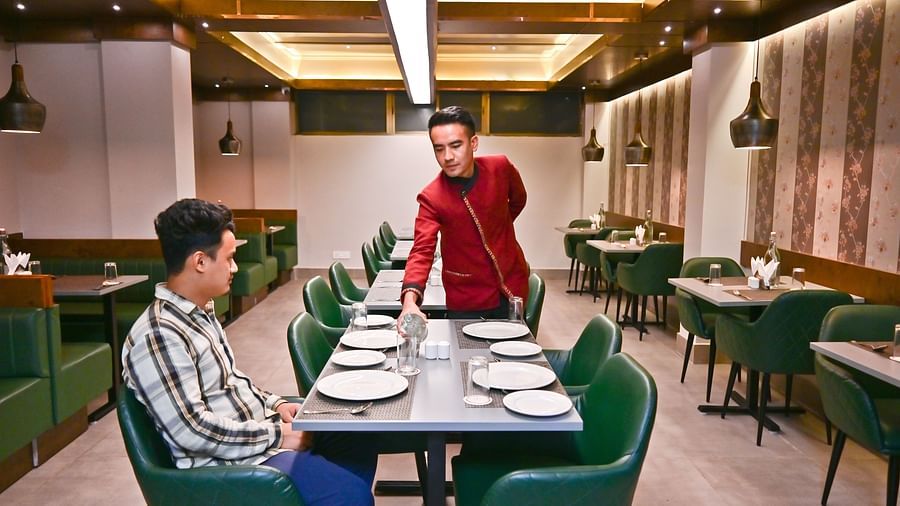 The waiter attending to guests in the restaurant at The Soma Hotel by Avianna Group, Darjeeling