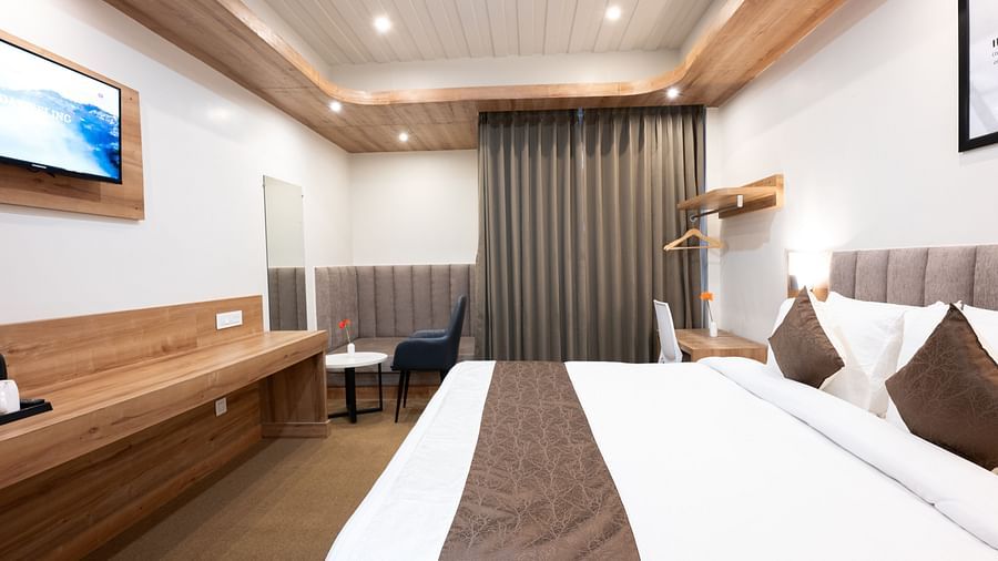 delux room image with a king size bed at the soma hotel by avianna group, darjeeling