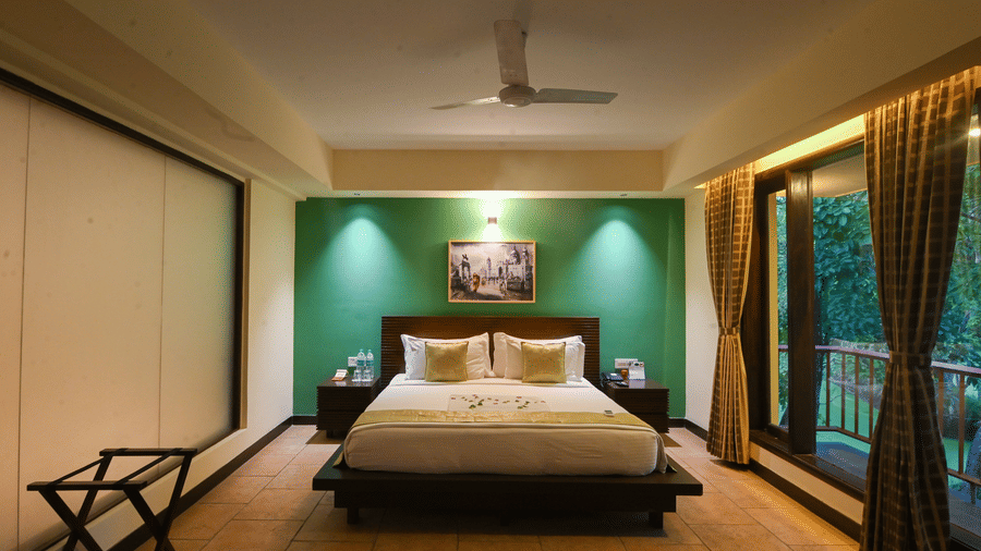 Elegant bedroom featuring a king-size bed and warm interiors at the resort.