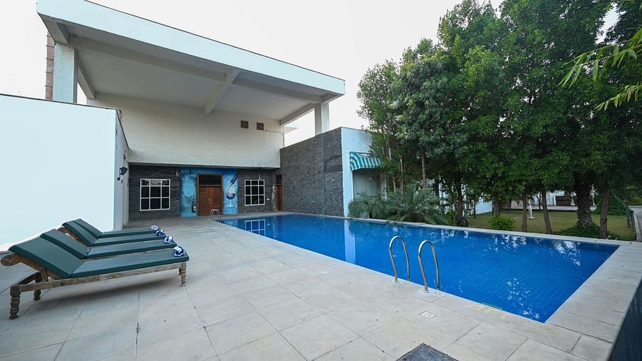 A swimming pool surrounded by trees - Clarks Safari, Ranthambore