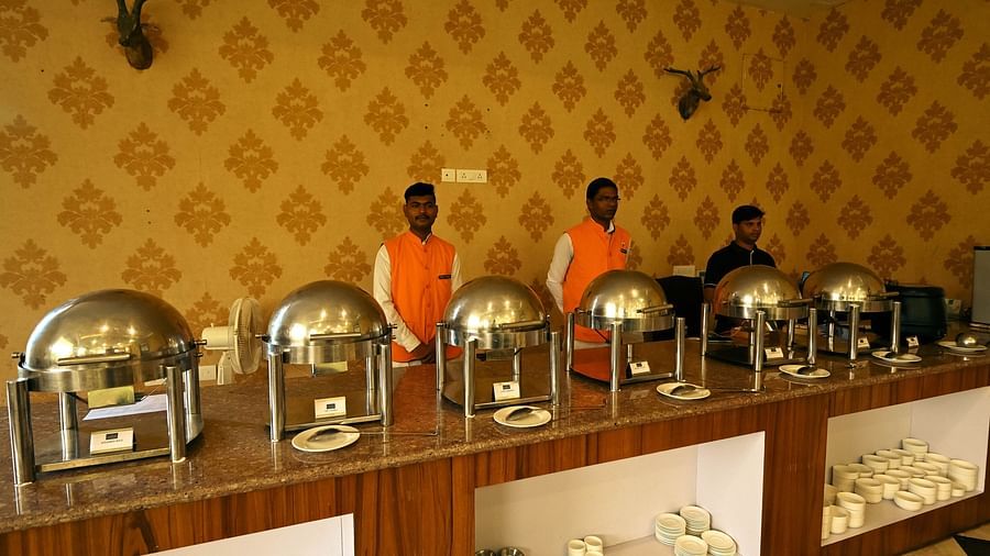 A restaurant featuring three people standing to serve the food - Clarks Safari, Ranthambore