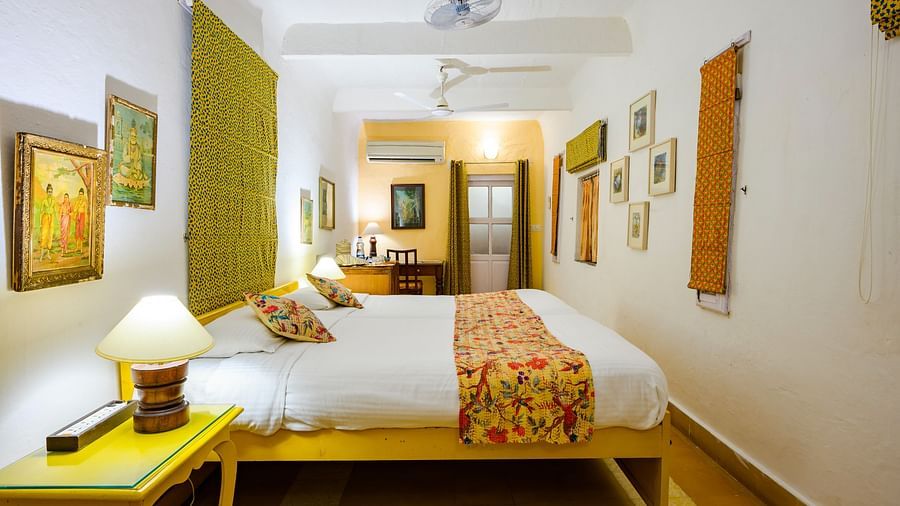 Hill Fort Kesroli 14th Century Alwar - interior view of the Pitambar Mahal with green decor featuring a king size bed
