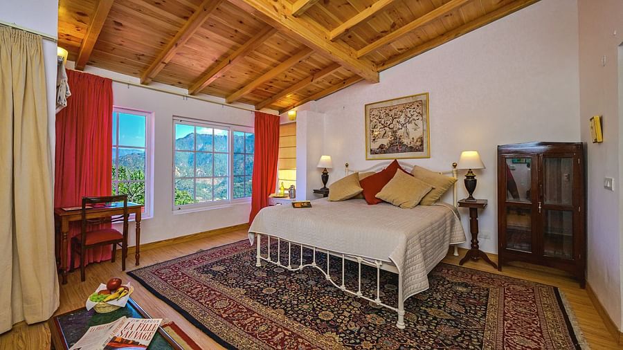 Rose room with a double bed, a small shelf, window and cosy interiors at The Ramgarh Bungalows - 19th Century, Above Nainital.