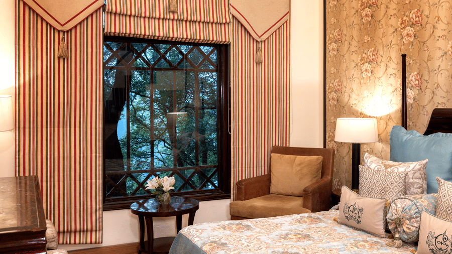 image of the window with beautiful views of trees from the Duplex Family Suite at The Claridges Nabha Residence