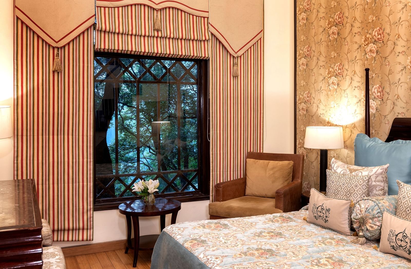 image of the window with beautiful views of trees from the Duplex Family Suite at The Claridges Nabha Residence