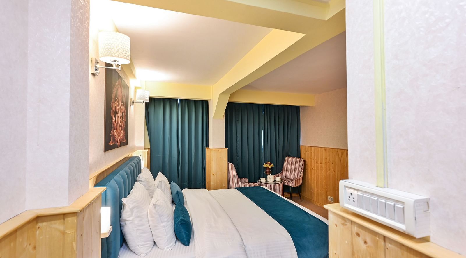 Deluxe Room with spacious bed, wooden furniture and warm lighitng at Avianna Seven Seas, Darjeeling12