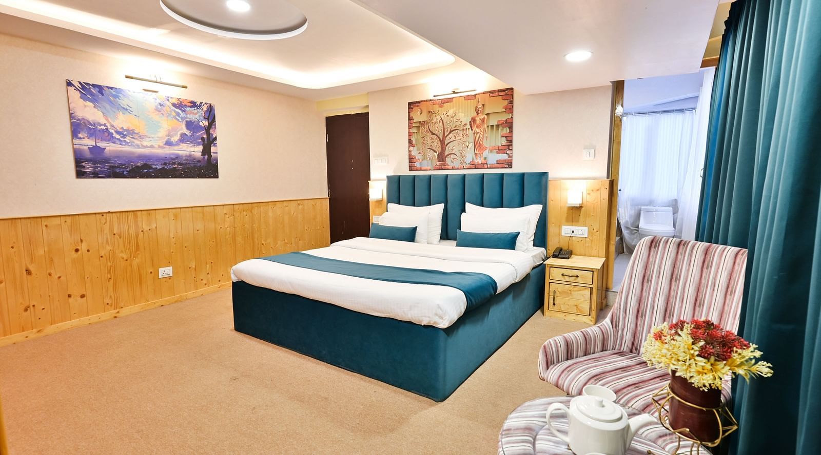 Deluxe Room with spacious bed, wooden furniture and warm lighitng at Avianna Seven Seas, Darjeeling4