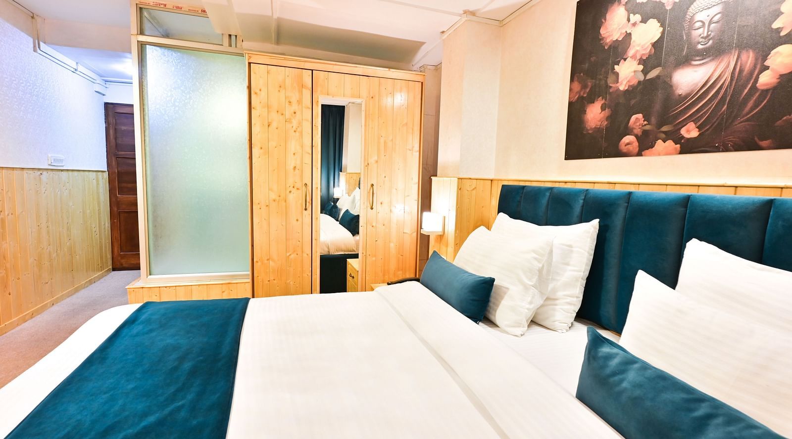 Deluxe Room with spacious bed, wooden furniture and warm lighitng at Avianna Seven Seas, Darjeeling7