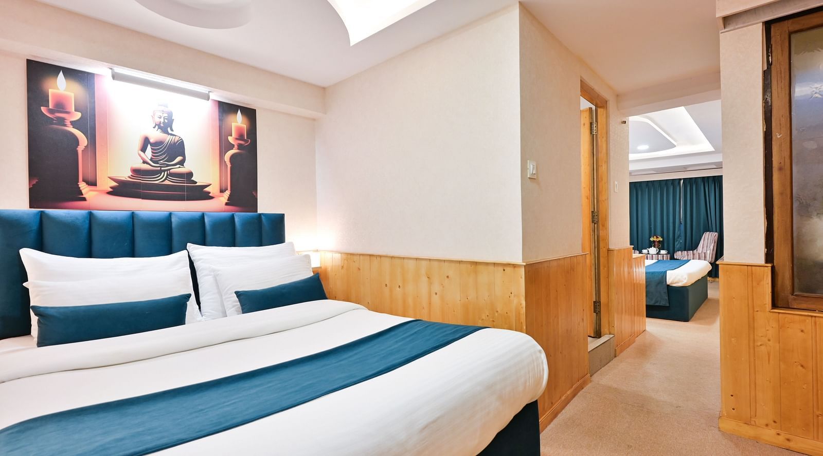 Family room with a king size bed, wooden cupboards, wooden bedside table with bright lighting, and a wall-mounted television at Avianna Seven Seas, Darjeeling4