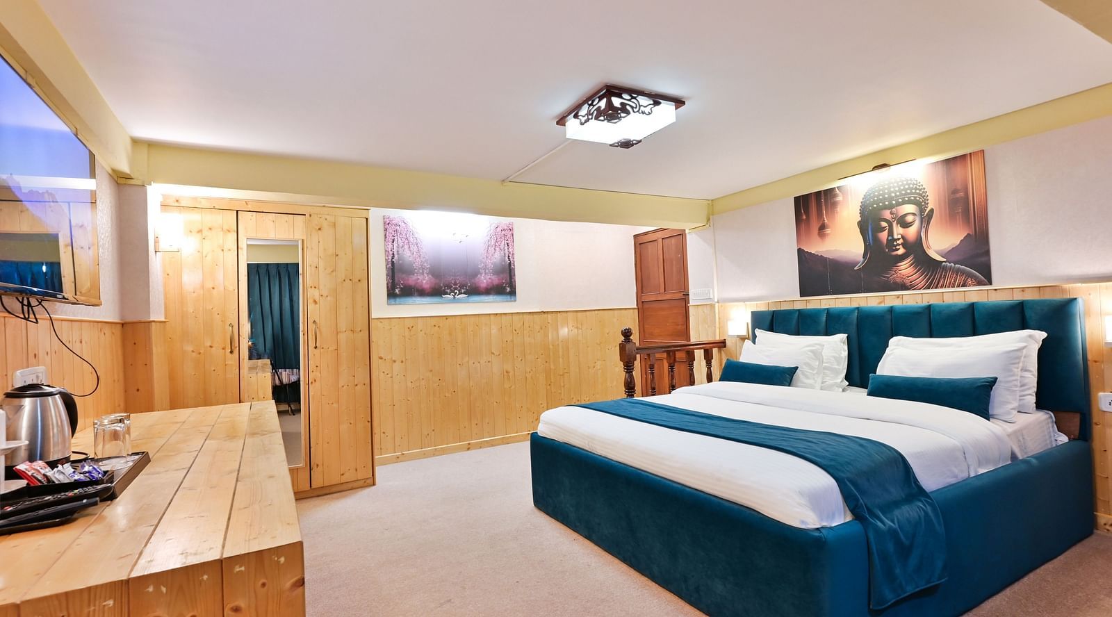 Premium room featuring a king sized bed, wall mounted television, windows with curtains, and warm lighting at Avianna Seven Seas, Darjeeling19
