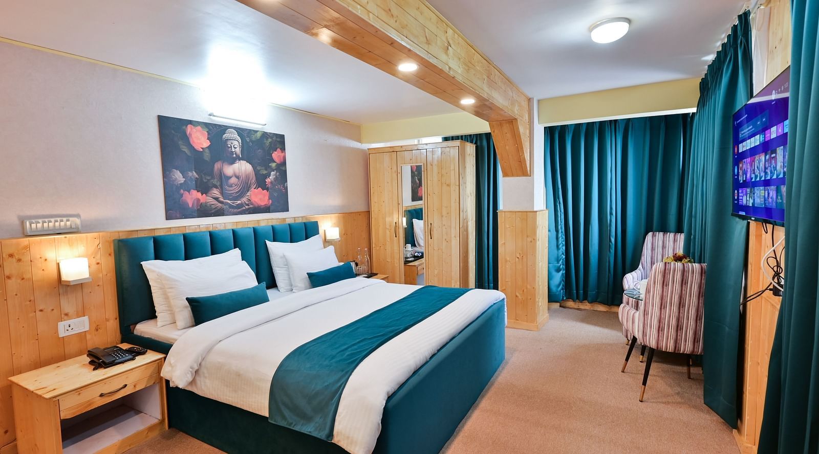 Premium room featuring a king sized bed, wall mounted television, windows with curtains, and warm lighting at Avianna Seven Seas, Darjeeling7