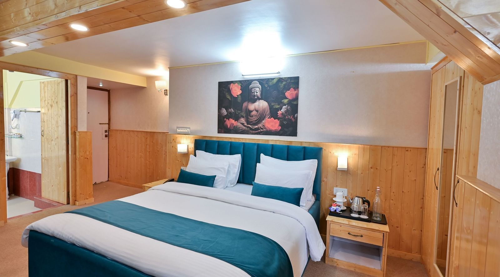 Premium room featuring a king sized bed, wall-mounted television, windows with curtains, and warm lighting at Avianna Seven Seas, Darjeeling1