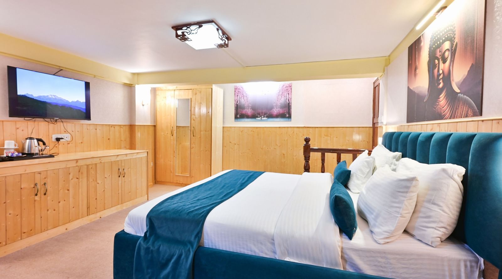 Premium room featuring a king  sized bed, wall mounted television, windows with curtains, and warm lighting at Avianna Seven Seas, Darjeeling17