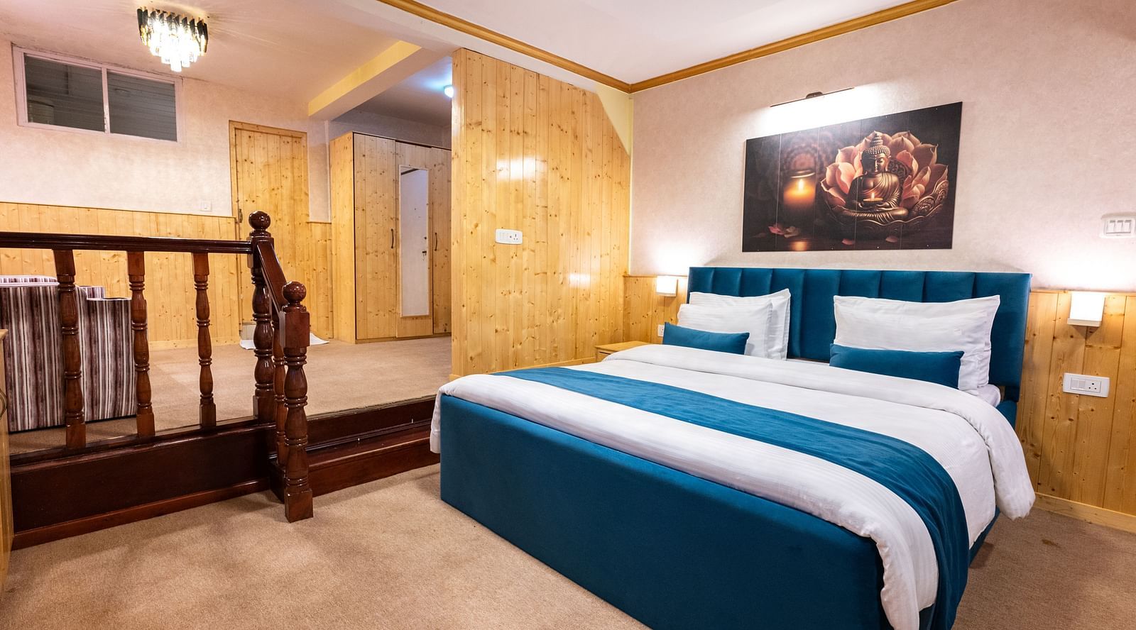 The suite features a spacious bed, large windows stretching along one side of the room, comfortable cushioned furniture, and warm lighting at Avianna Seven Seas, Darjeeling7