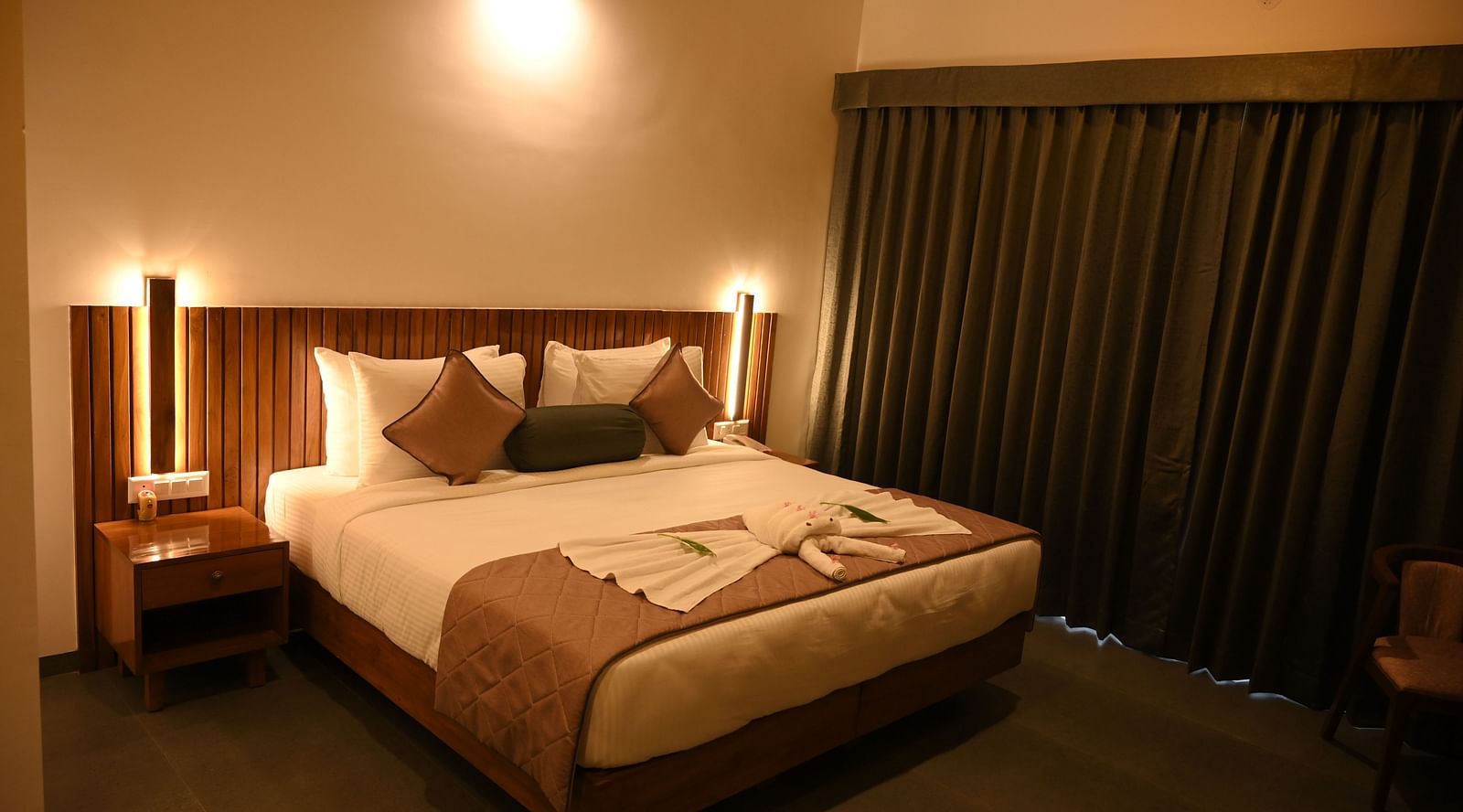 A double bed in the Deluxe Cottage at Mango Leaf Lake Resort, Pune