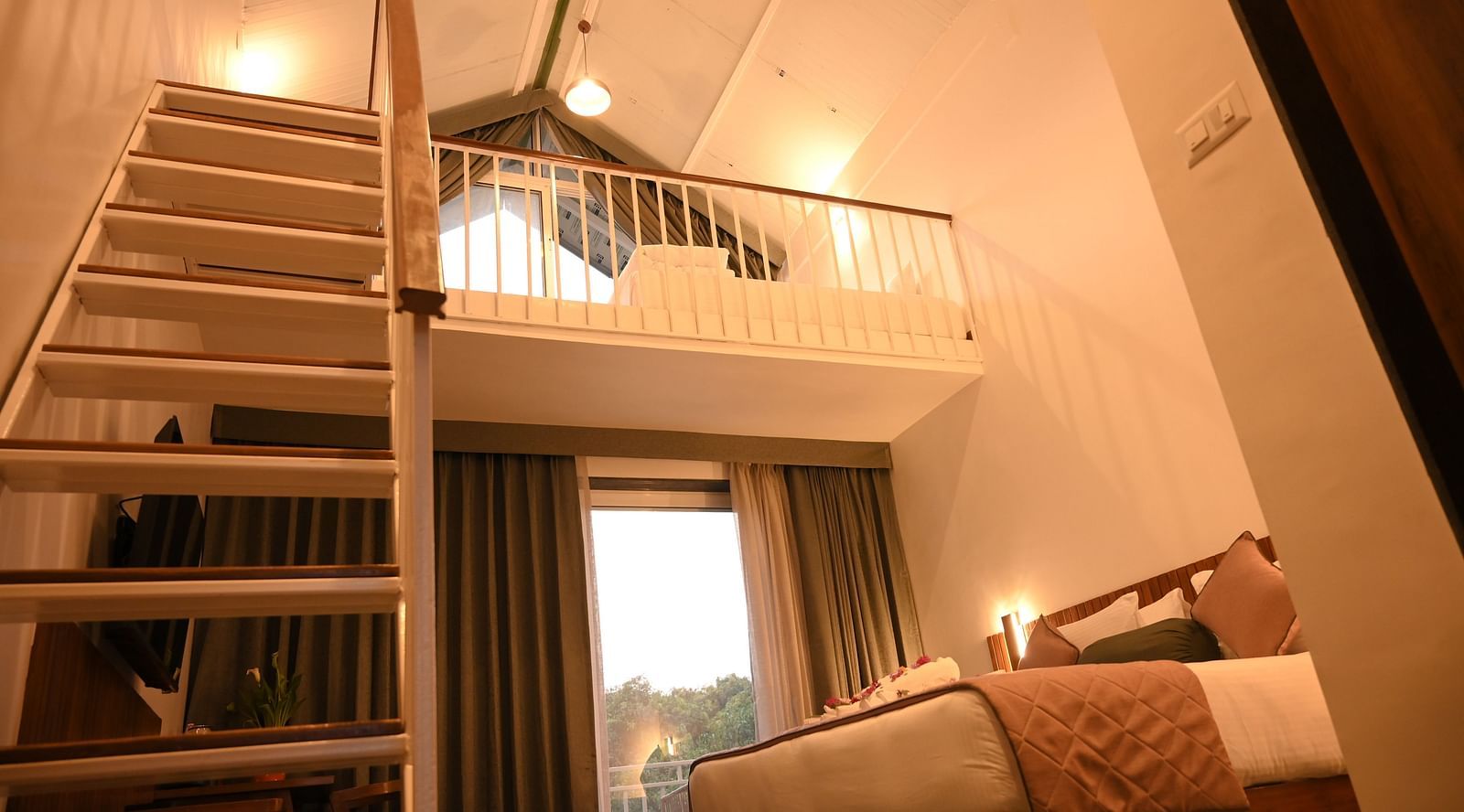Another view of the staircase leading to the attic of the Kutumbh Suite at Mango Leaf Lake Resort, Pune