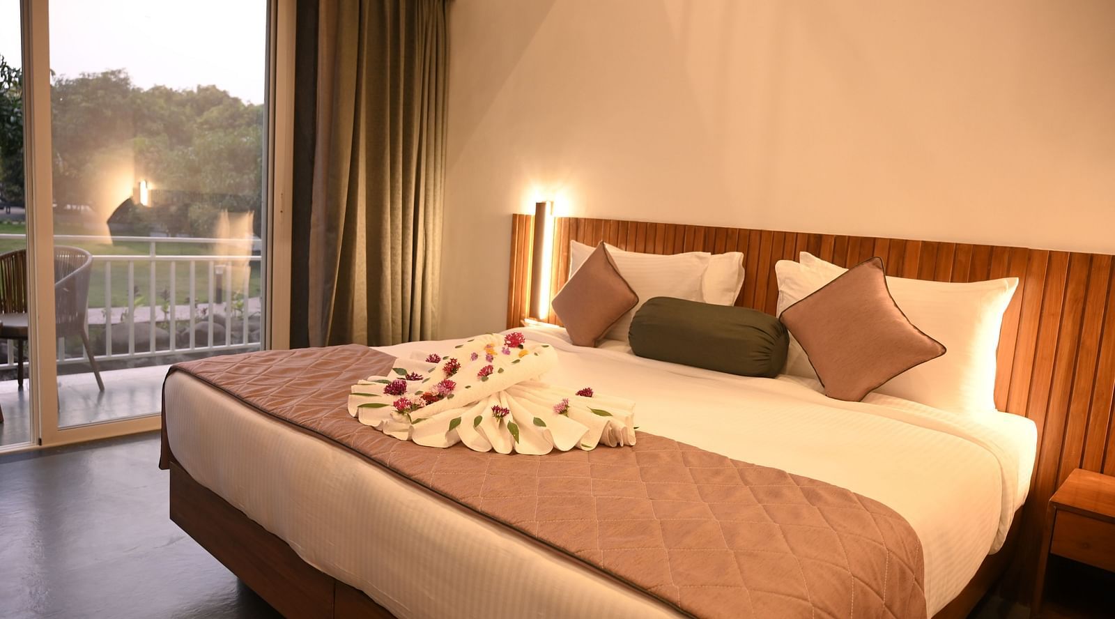 Side view of a double bed at the Kutumbh Suite at Mango Leaf Lake Resort, Pune