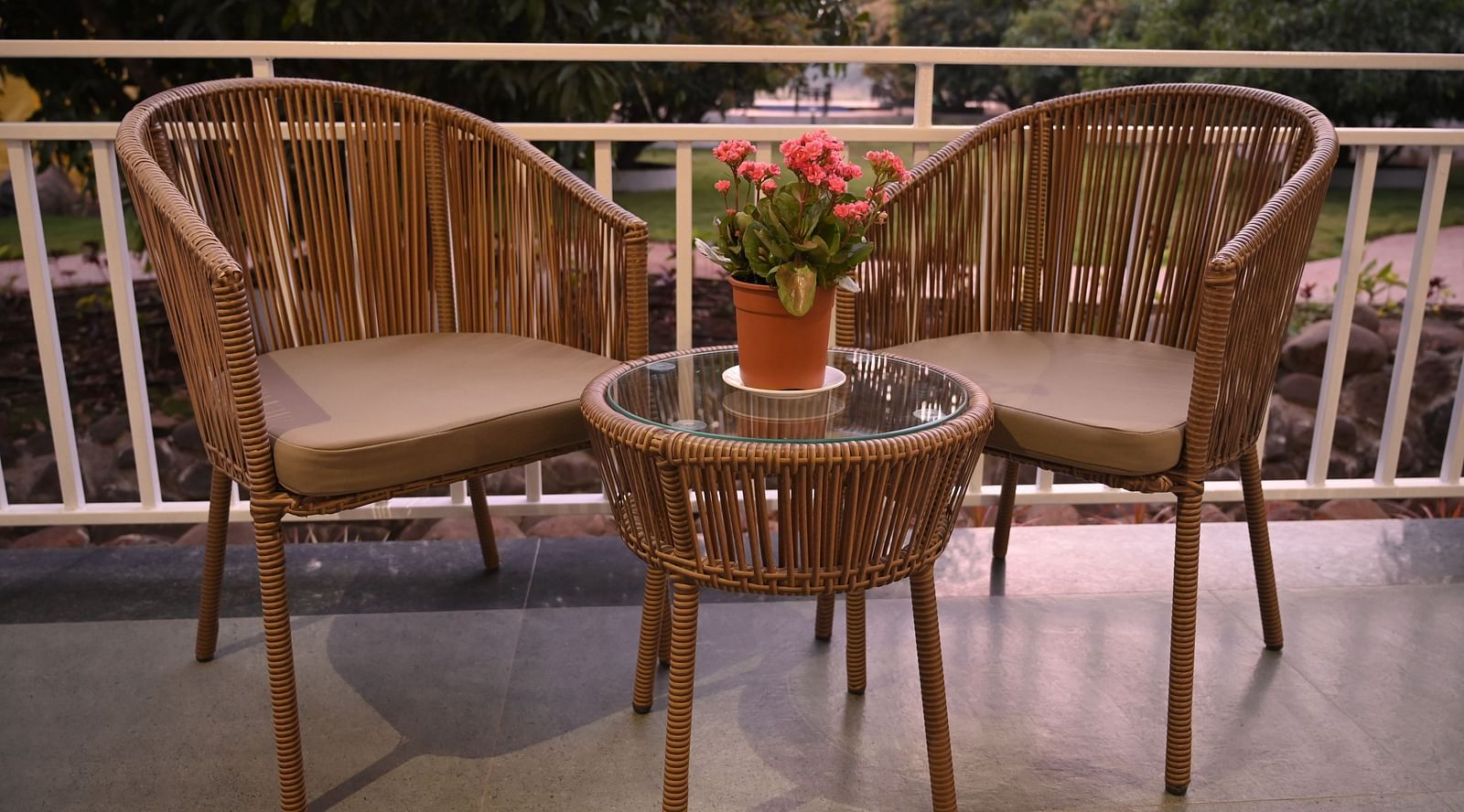 Two chairs kept on the patio at Mango Leaf Lake Resort, Pune