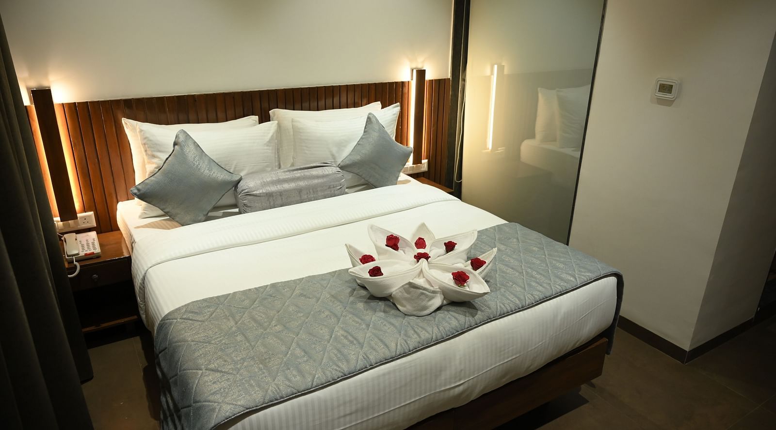 Wide view of the double bed at at Deluxe room at  Mango Leaf Lake Resort, Pune