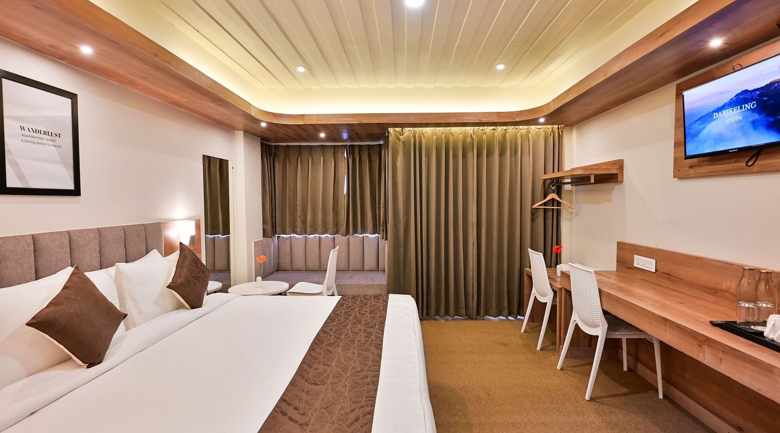 premium rooms with a sitting area and two white chairs at the soma hotel by avianna group, darjeeling