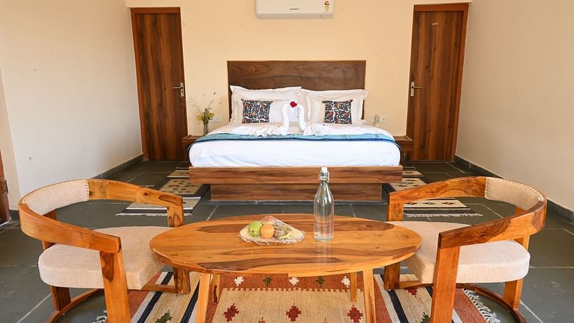 Clarks Safari Jawai - a view of the bedroom and the seating space offered by the cottage room with plunge pool in Jawai