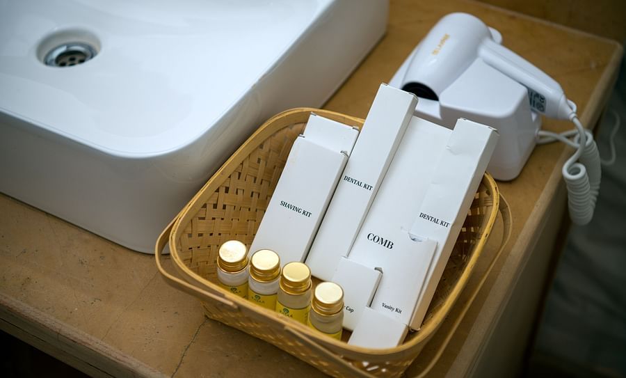 alt-text A tray near the wash basin contains shaving kit, vanity kit and a few more kits - Karwaan Jaisalmer