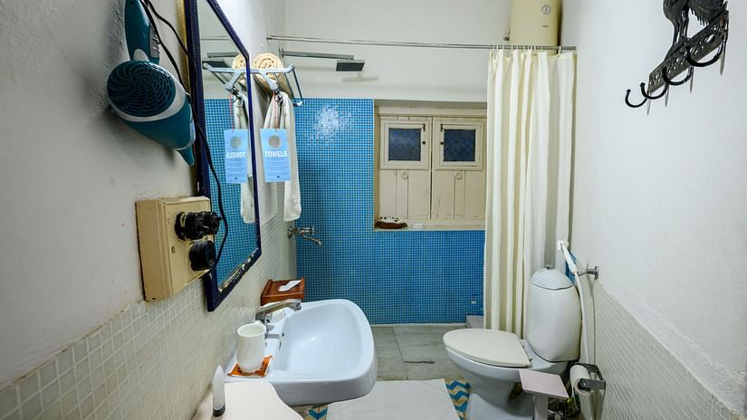 Hill Fort Kesroli 14th Century Alwar - interior view of the Mayur Bathroom with a wash basin, commode, mirror and a shower area