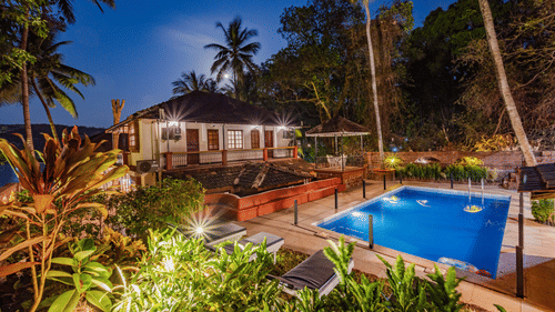 Swimming pool with lounger chairs at Neemrana s Three waters