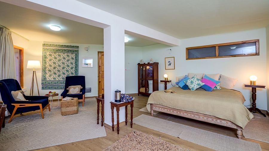 Spacious Fig room with a double bed and sitting area at The Ramgarh Bungalows - 19th Century, Above Nainital.