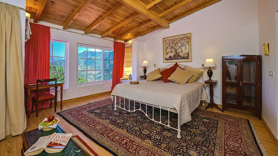 Rose room with a double bed, a small shelf, window and cosy interiors at The Ramgarh Bungalows - 19th Century, Above Nainital.
