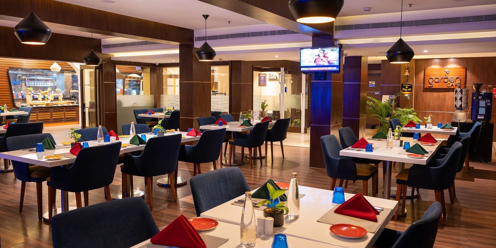An image of  a dining space with a television  at Grand Kakinada by GRT Hotels