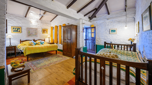 Lemon Room featuring a queen size bed and a single bed with a wardrobe and wooden ceiling - Ramgarh Bungalows, Nainital.