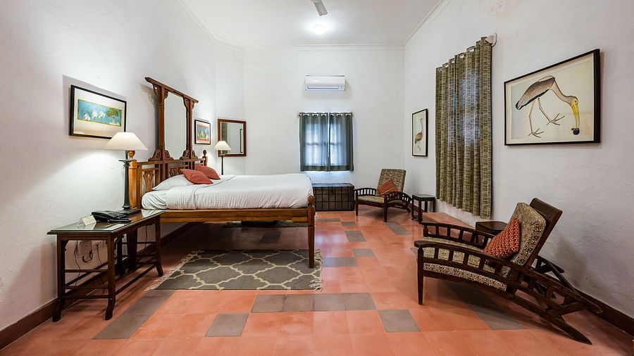 Hill Fort Kesroli 14th Century Alwar - interior view of the Rajhans Mahal - Countryside View with a  king size bed, a ceiling fan and paintings hanging on the wall