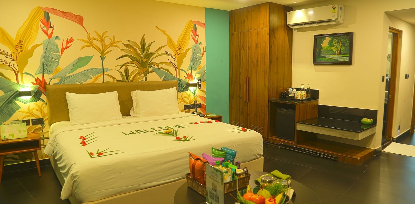 An image of a a valley view room with king size bed, bed side table, wardrobe, air-conditioner, and decorative items - Great Trails Yercaud by GRT Hotels