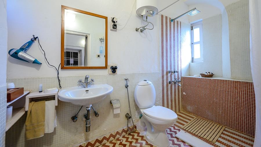 Hill Fort Kesroli 14th Century Alwar - interior view of the Baaj Mahal - Garden View Washroom featuring a commode, wash basin, mirror, a hairdryer  and a shower space