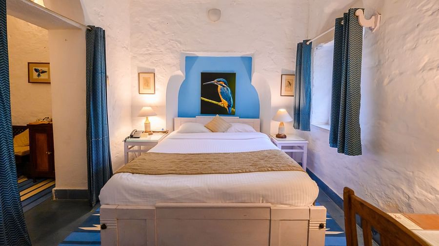 Interior view of the Neelkanth Mahal - Countryside View room with a queen size bed and lamps on either sides
