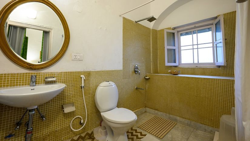 Hill Fort Kesroli 14th Century Alwar - interior view of the Hariyal Bathroom featuring a commode, wash basin and a mirror