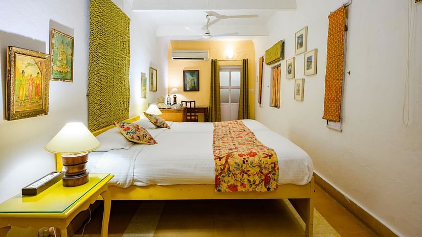 Hill Fort Kesroli 14th Century Alwar - interior view of the Pitambar Mahal with green decor featuring a king size bed
