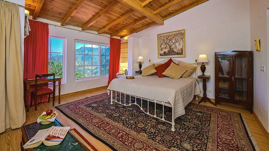 Rose room with a double bed, a small shelf, window and cosy interiors at The Ramgarh Bungalows - 19th Century, Above Nainital.