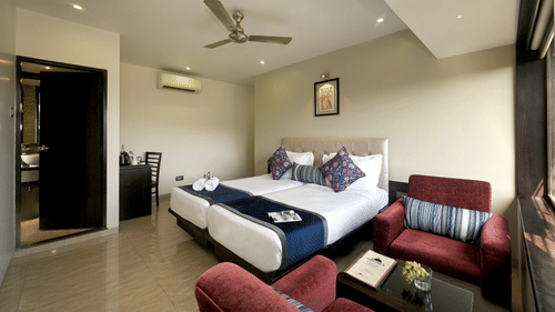 Premium room with bed and cosy sitting area