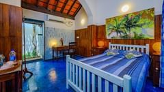 a room with king size bed and blue bed sheet