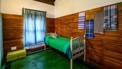 single bed room with wooden interior 